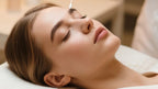 Brow lamination treatment in progress as a gloved technician applies product to the eyebrow with a cotton applicator.
