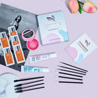 Flat lay of the PERMANIA brow lamination kit with box, instruction manual, lotions, essence sachets, glue balm and applicator brushes.