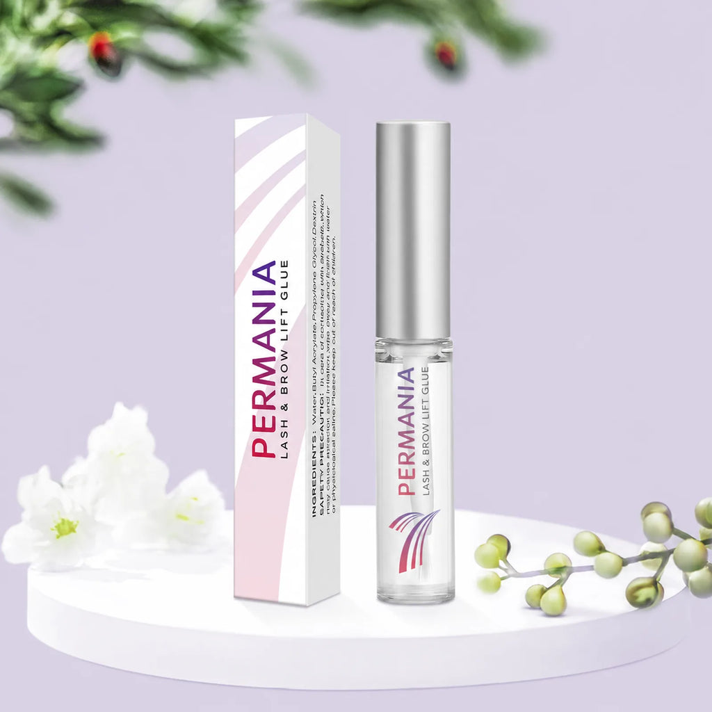 PERMANIA lash and brow lift glue bottle and matching box displayed on a pale purple platform with white flowers.